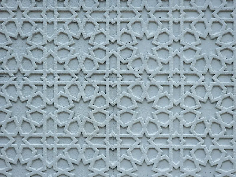 White wall panel with a raised geometric star pattern